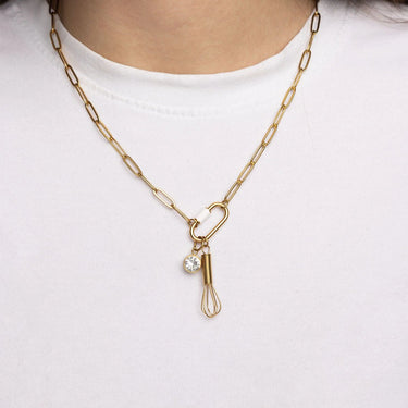 Gold necklace with a unique pendant on a white background