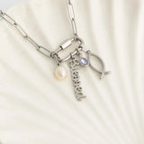 Silver bracelet with charms on a light beige background