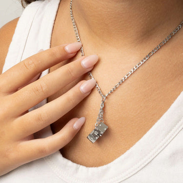 Silver necklace with a Dice Charm  worn by a person