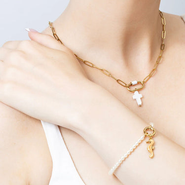 Gold Shell Cross Charm on necklace 