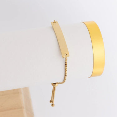 Gold hoop earrings on a light gray background
