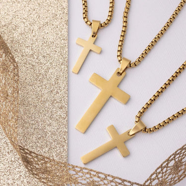 Gold cross necklaces on a textured gold and white background