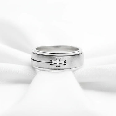 Silver ring with a design on a white background
