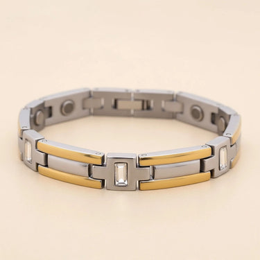 Silver and gold bracelet on a beige background