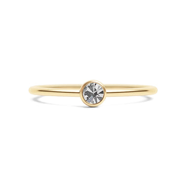 Gold ring with a single diamond on a white background