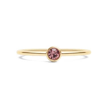 Gold ring with a pink gemstone on a white background