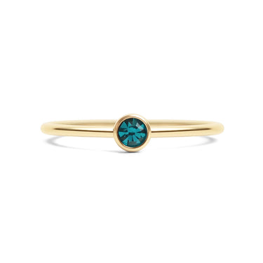 Gold ring with a green gemstone on a white background