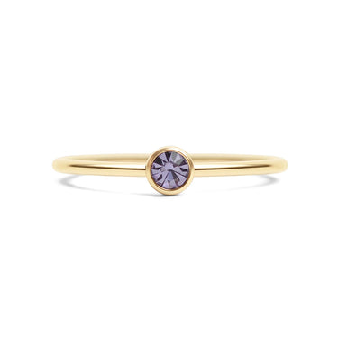 Gold ring with a purple gemstone on a white background