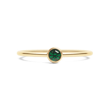 Gold ring with a green gemstone on a white background