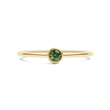 Gold ring with a green gemstone on a white background