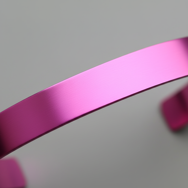 Detail of flat pink aluminum cuff bracelet blank surface for engraving