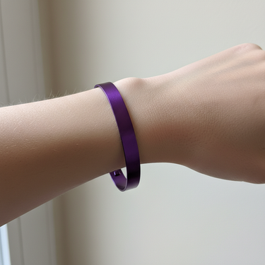 Purple aluminum cuff bracelet worn snugly on female wrist