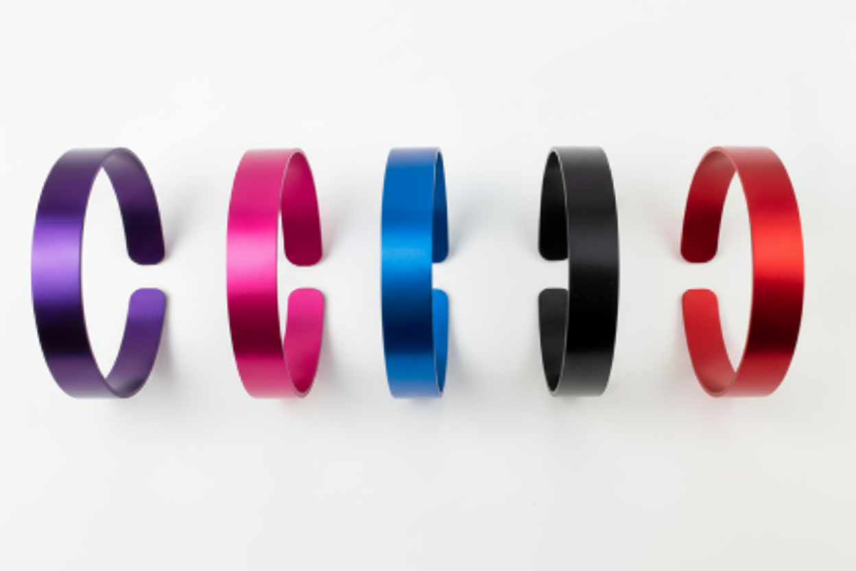 Five colored aluminum cuff bracelets - purple, pink, blue, black, and red