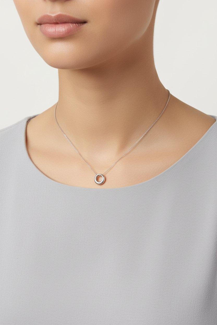 Stainless steel circle pendant worn on chain by model