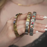 wholesale jewelry Italian charm Collection shot: stainless heart with arrow, stainless football, stainless butterfly, stainless birthstone, stainless strawberry, stainless floral, stainless full heart, gold heart, gold star and gold colorful stone charms 