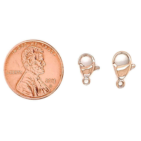 Stainless steel rose gold PVD Coated lobster clasps with a penny for scale.