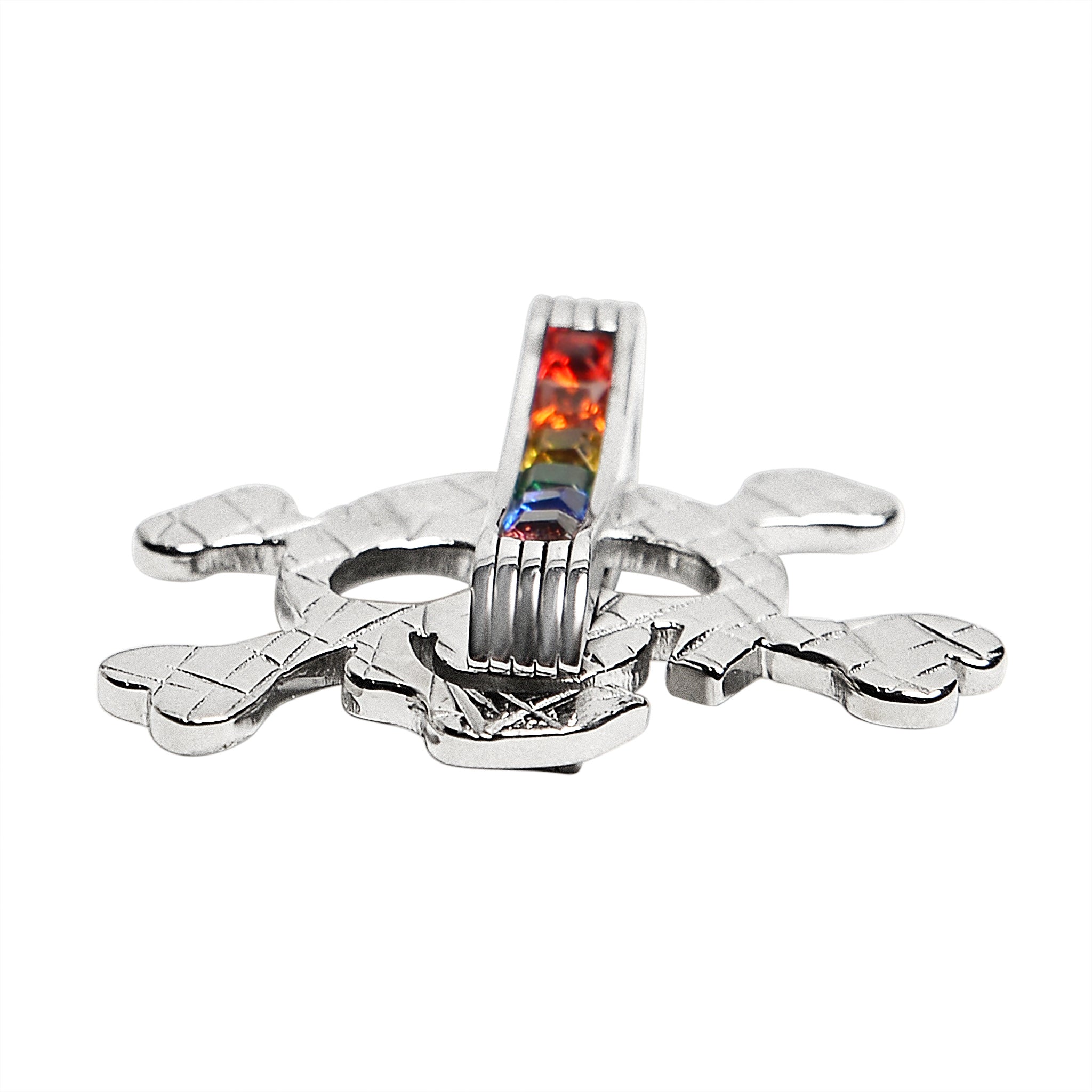 Stainless steel Cubic Zirconia skull and crossbones rainbow pendant at an angle.