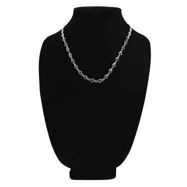 Stainless steel hexagon fancy chain necklace on a black velvet bust.