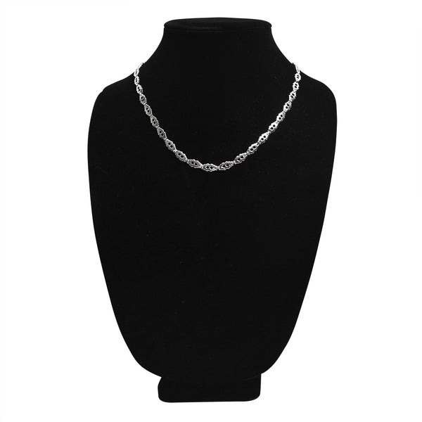Stainless steel fancy chain necklace on a black velvet bust.