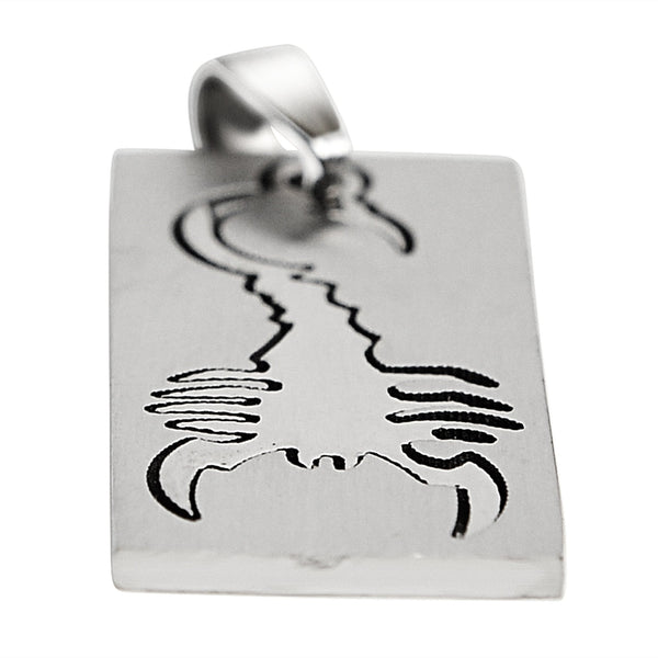 Stainless steel cutout scorpion pendant at an angle.