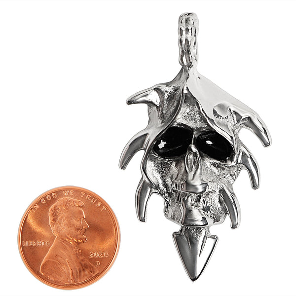 Stainless steel hooded black eyed skull pendant with a penny for scale.