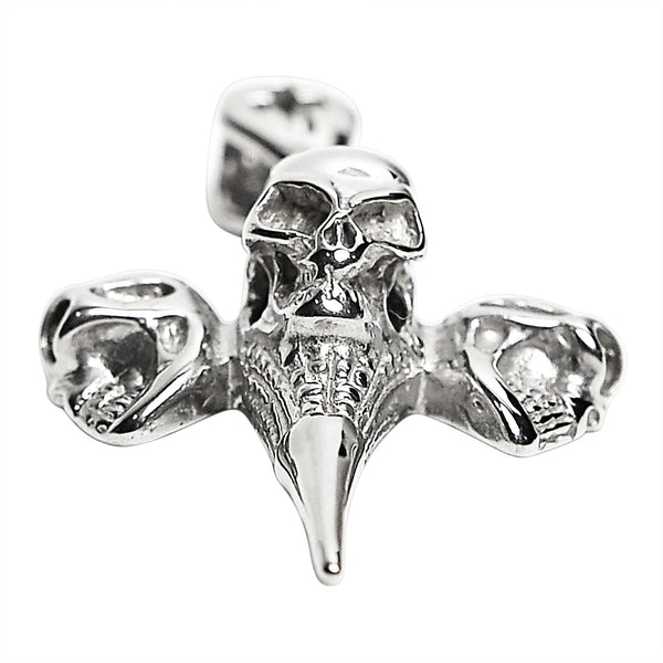 Stainless steel three skulls Cross pendant at an angle.