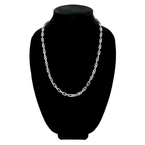 Stainless steel bike chain necklace on a black velvet bust.