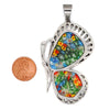 Millefiori butterfly stainless steel pendant with a penny for scale.