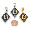 Stainless steel "13" pendants in three different colors with a penny for scale.