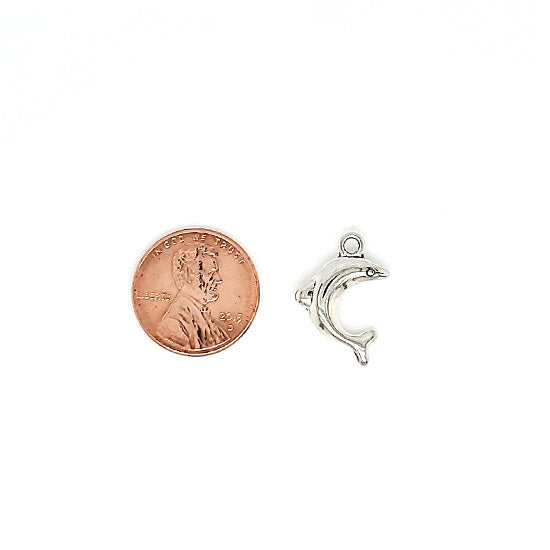 Small dolphin charm with a penny for scale