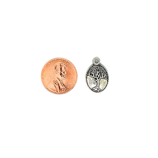 Small oval tree charm with a penny for scale.