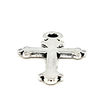 Small cross charm at an angle.