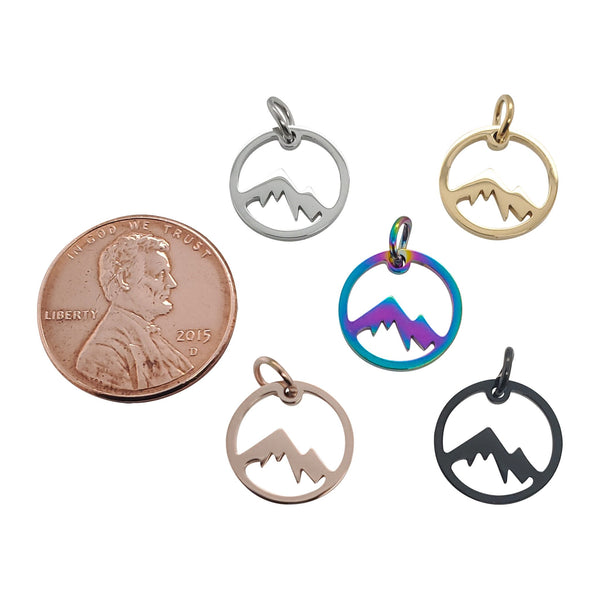 Stainless steel mountain charms in a variety of colors with a penny for scale.