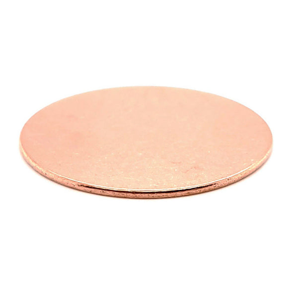 Copper blank round disc at an angle.