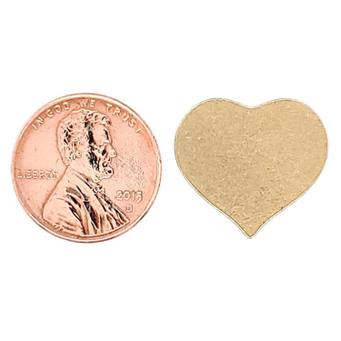 Brass blank heart pendant with a penny for scale.