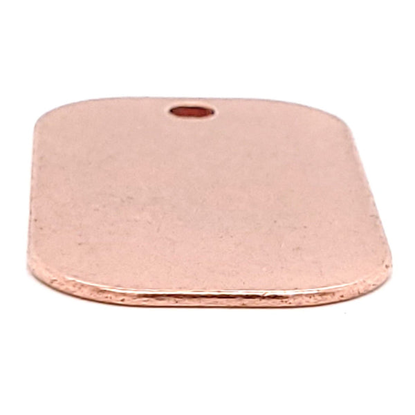 Copper blank dog tag pendant at an angle.