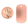 Copper blank dog tag pendant with a penny for scale.