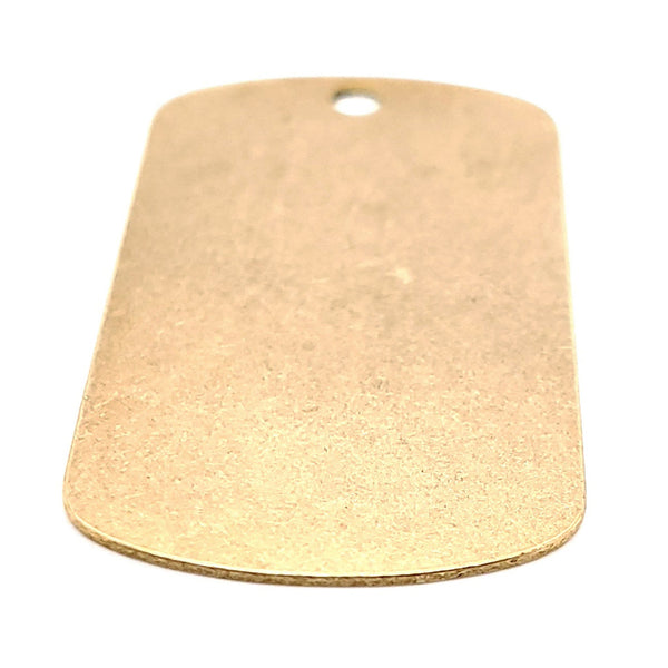 Brass blank dog tag pendant at an angle.