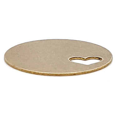 Brass blank round heart cutout pendant at an angle.