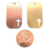 Copper and brass blank cross cutout dog tag pendants with a penny for scale.