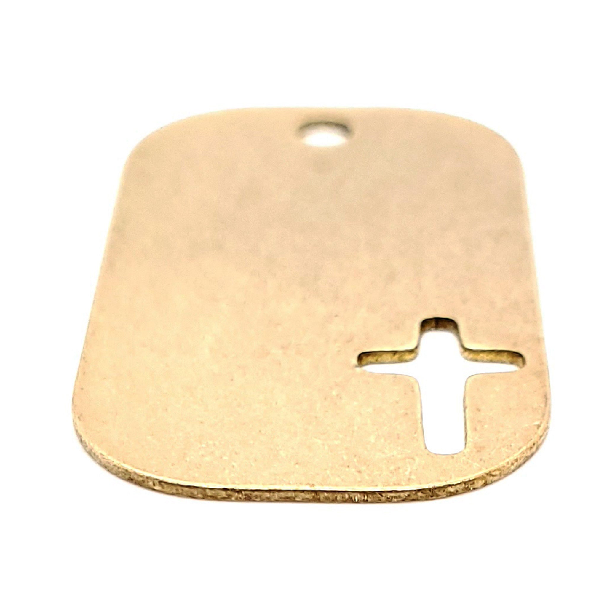 Brass blank cross cutout dog tag pendant at an angle.