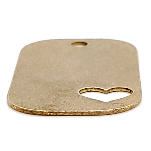 Brass blank heart cutout dog tag pendant at an angle.