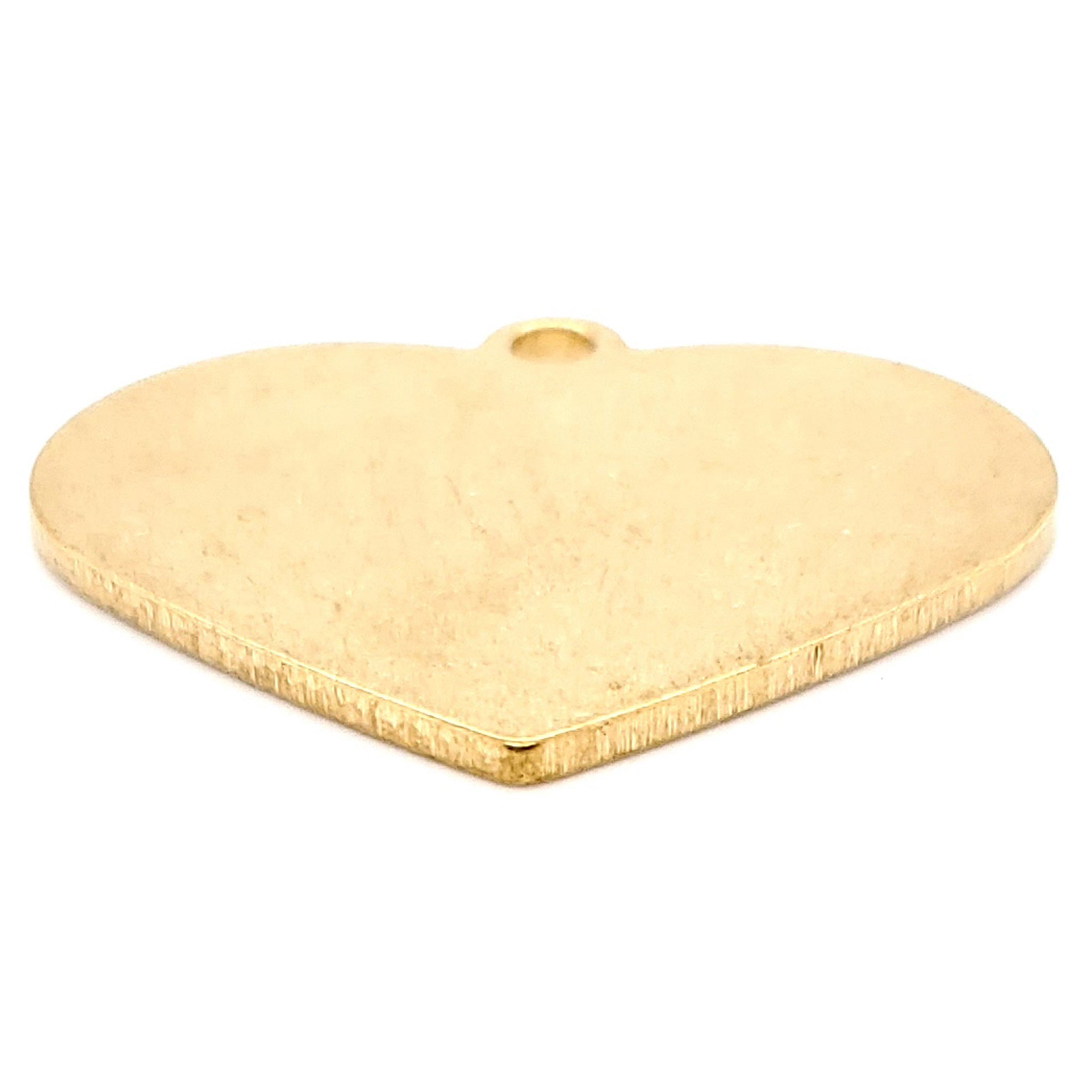 Brass blank holed heart pendant at an angle.