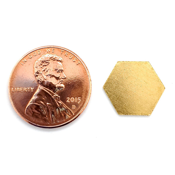 Brass blank hexagon pendant with a penny for scale.