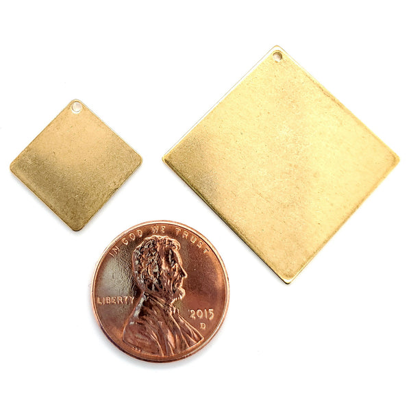 Brass blank diamond pendant in two different sizes with a penny for scale.