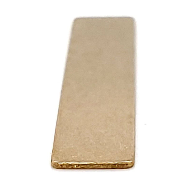 Brass blank rectangle pendant at an angle.