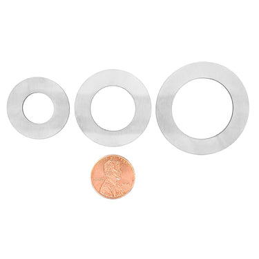 Stainless steel blank washer pendant in a variety of sizes with a penny for scale.