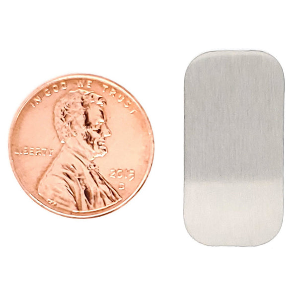 Stainless steel blank rounded rectangle pendant with a penny for scale.