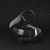 Stainless steel black wrench ring on a black leather background.