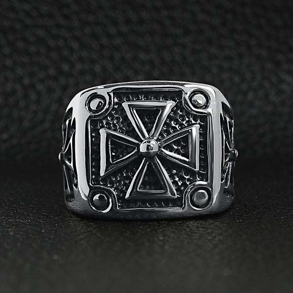 Stainless steel polished Maltese Cross ring on a black leather background.